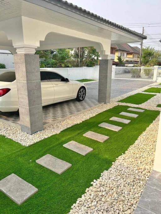 Modern driveway with covered carport and landscaped walkway