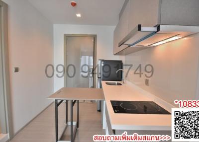 Modern kitchen with stainless steel appliances and white countertops in a new apartment