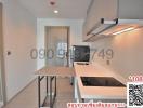 Modern kitchen with stainless steel appliances and white countertops in a new apartment