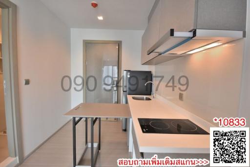 Modern kitchen with stainless steel appliances and white countertops in a new apartment