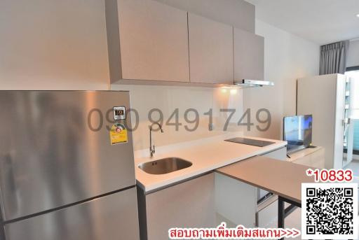 Modern kitchen with stainless steel appliances and bar counter