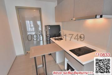 Modern compact kitchen with white cabinetry and built-in appliances