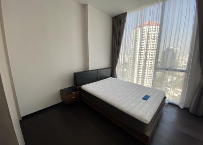 Modern bedroom with large window and city view