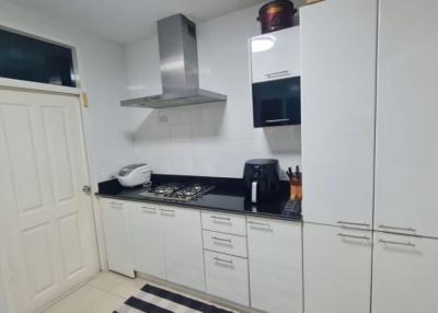 Modern kitchen with stainless steel appliances and white cabinetry