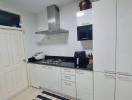 Modern kitchen with stainless steel appliances and white cabinetry