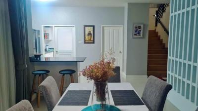 Modern dining area with open concept to kitchen and staircase