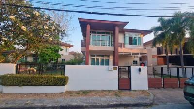 Exterior view of a modern two-story house with a white fence