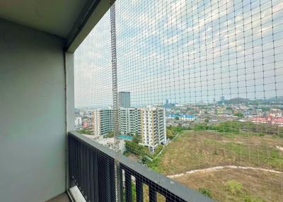 High-rise apartment balcony with a protective net overlooking a cityscape