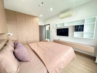 Modern bedroom interior with king-sized bed, built-in wardrobes and flat screen TV