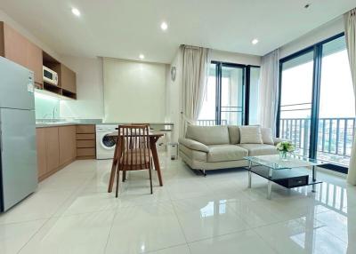Modern apartment interior with open plan living room and kitchen, natural light, and clean design
