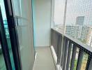 High-rise apartment balcony with city view and safety railing