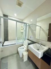 Spacious modern bathroom with bathtub and large window