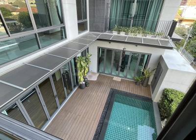 Spacious balcony with a private pool and lounge area
