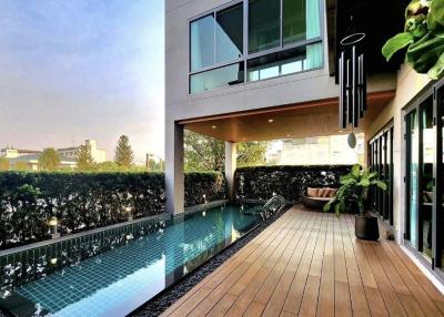 Modern outdoor patio with a swimming pool and wooden decking