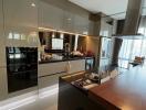 Modern kitchen with reflective surfaces and plenty of natural light