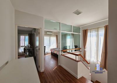 Spacious living room with ample natural light featuring a balcony and open-plan layout