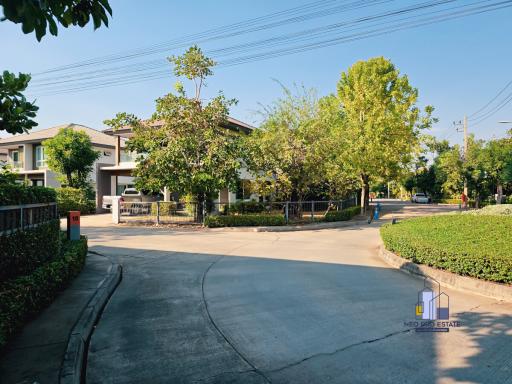 Suburban home exterior with landscaped driveway and greenery