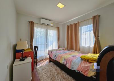 Bright cozy bedroom with a single bed and air conditioning unit