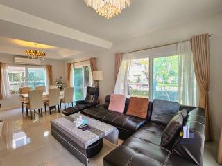 Spacious and well-lit living room with modern furnishings and a view of the garden