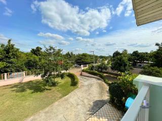 Spacious front yard with driveway and gated entrance