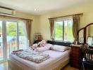 Cozy well-lit bedroom with balcony access