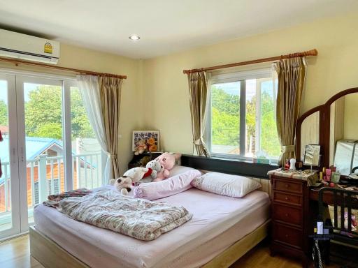 Cozy well-lit bedroom with balcony access