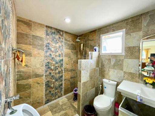 Modern tiled bathroom with walk-in shower and window