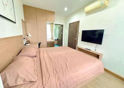 Cozy furnished bedroom with a large bed and modern amenities