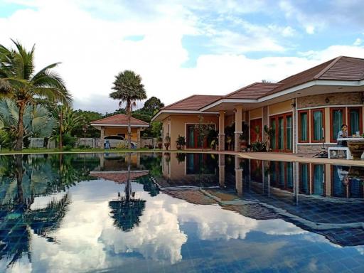 Spacious backyard with swimming pool and a view of a single-story house