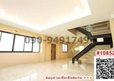 Spacious living room with modern staircase and tiled flooring
