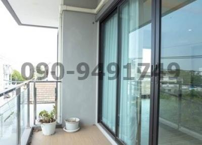 Apartment balcony with sliding glass doors and city view