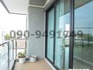 Apartment balcony with sliding glass doors and city view
