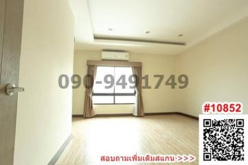 Spacious unfurnished bedroom with hardwood floors and large window
