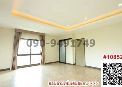 Spacious unfurnished living room with large windows and hardwood floors