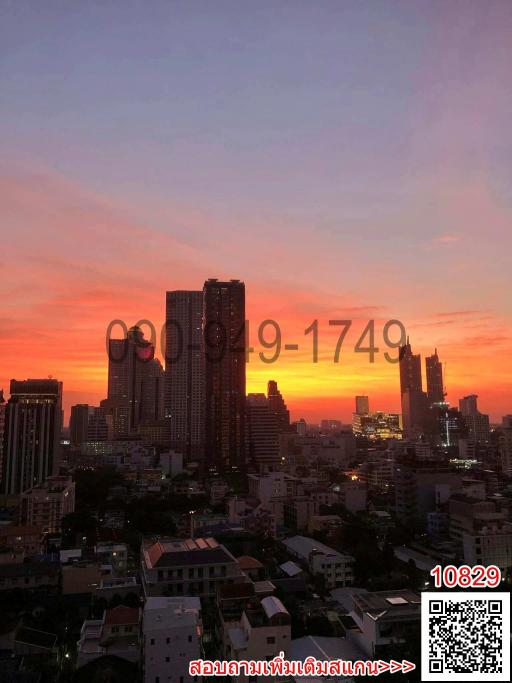 Scenic cityscape at sunset with modern buildings and vibrant sky