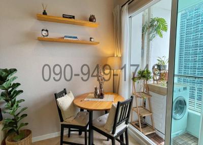 Cozy and well-lit dining area with modern furniture and a balcony view