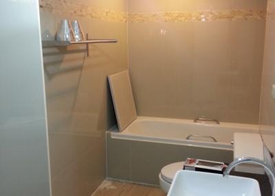 Modern bathroom with glass shower enclosure and tiled walls