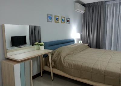 Cozy bedroom interior with queen size bed, study desk, and flatscreen TV