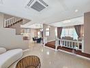 Spacious Living Room with Open Floor Plan and Elegant Staircase