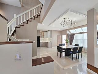 Spacious modern living and dining area with staircase