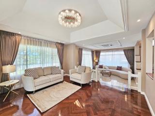 Spacious and elegantly furnished living room with natural light