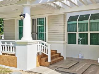 Elegant exterior of a suburban house with white pillars and large windows