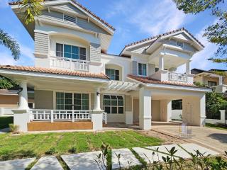 Spacious two-story house with balcony and well-manicured front yard