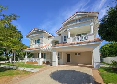 Spacious two-story house with large windows and a balcony