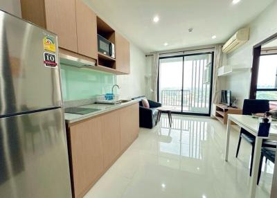 Spacious and modern apartment interior with open-plan kitchen, living and work area, bright natural light