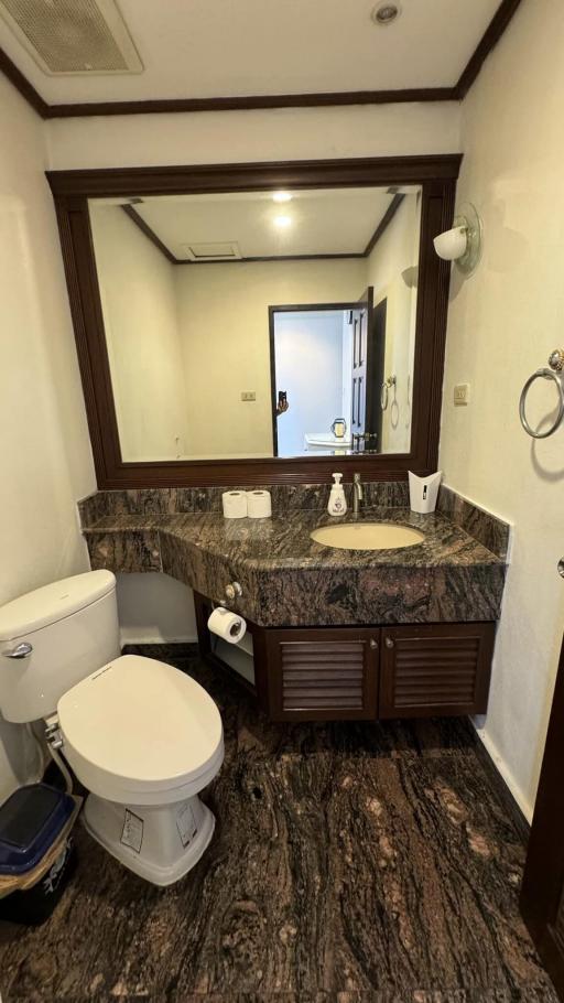 Contemporary bathroom with marble countertop and large mirror