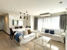 Spacious white-themed living room with ample natural light