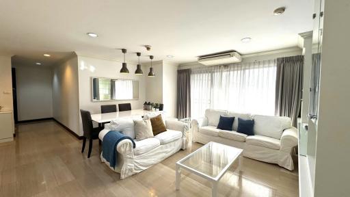 Spacious white-themed living room with ample natural light