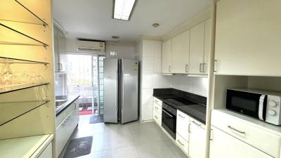 Modern kitchen with white cabinetry and stainless steel appliances