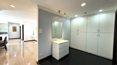 Spacious hallway with built-in wardrobes and glossy tiled flooring